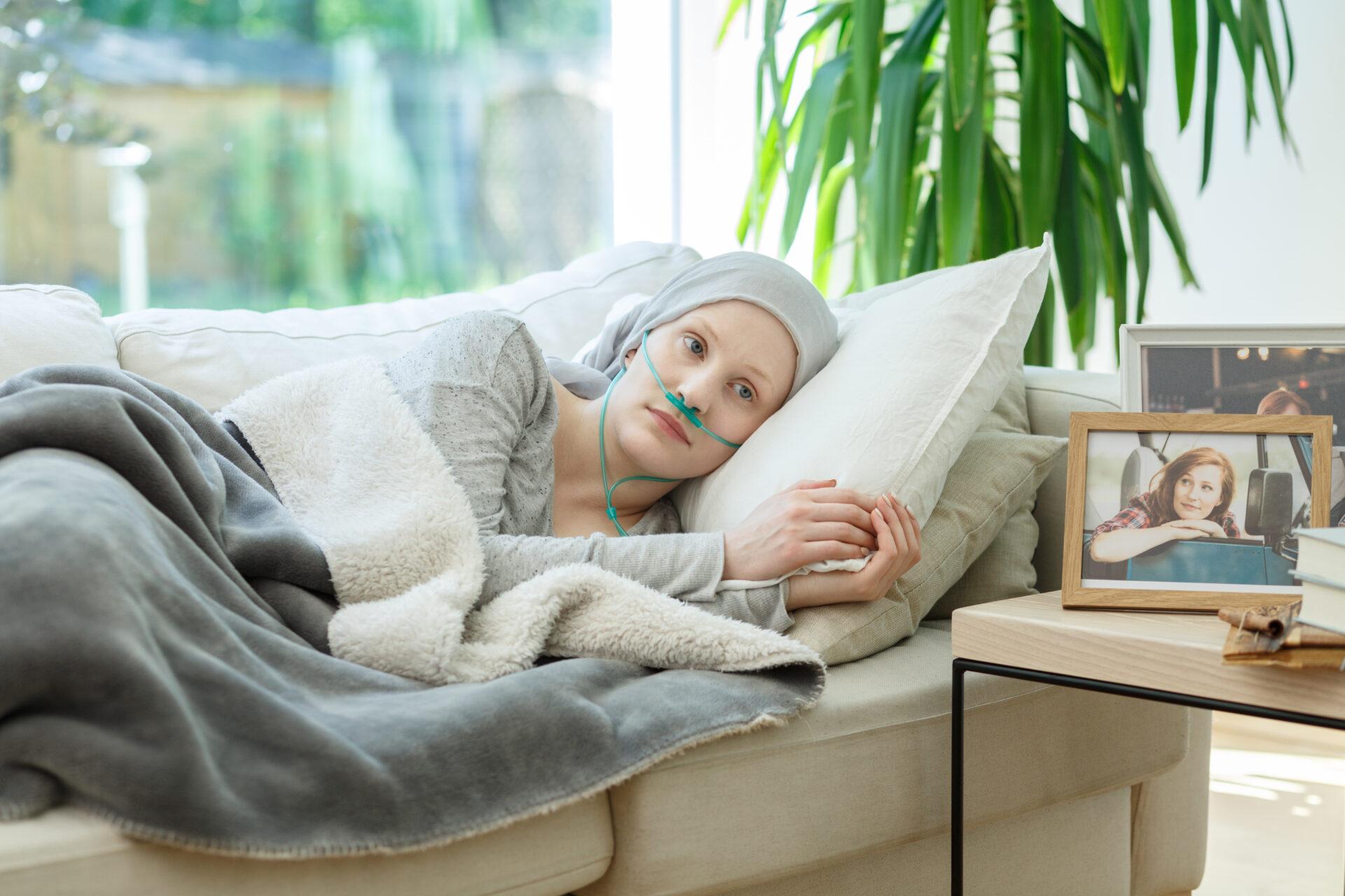 Female cancer patient in bed after chemotherapy treatment.