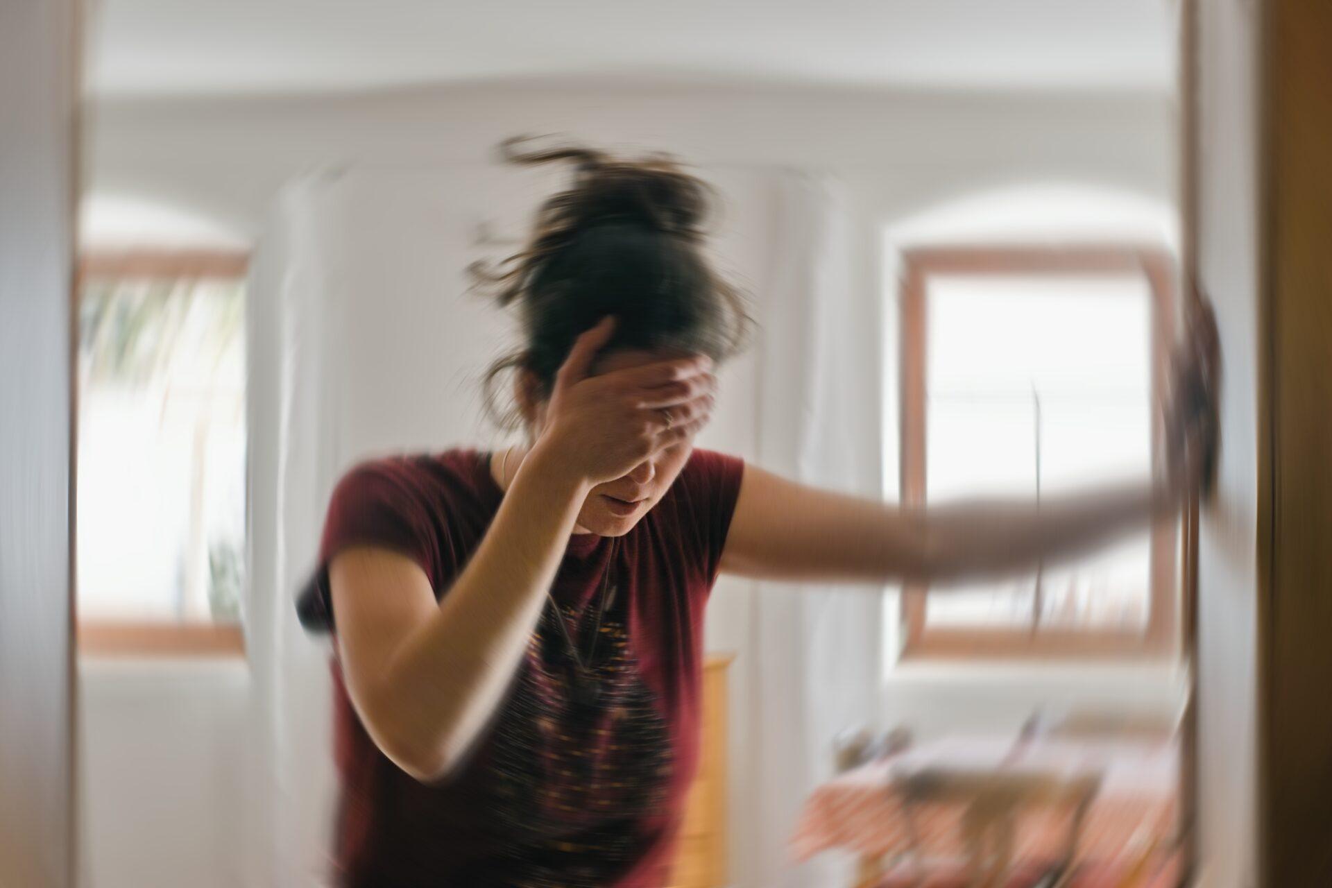 Blurred photo of a woman suffering from dizziness caused by epilepsy.