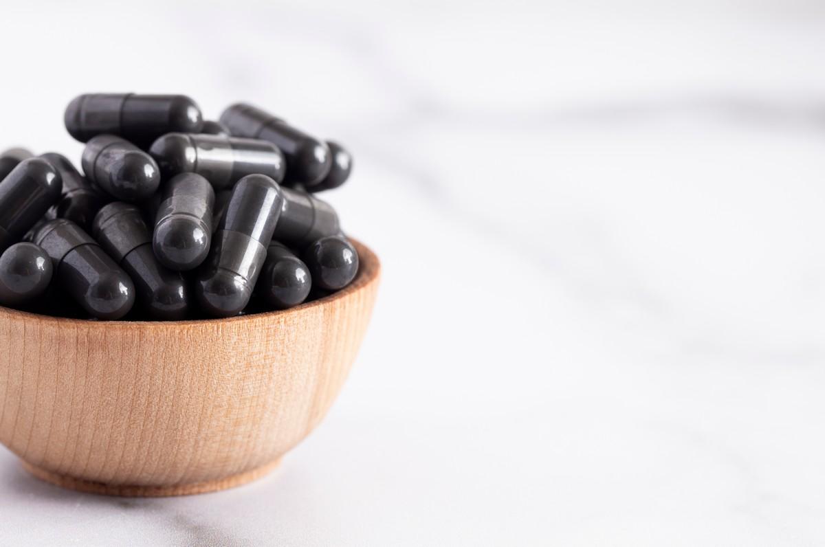 A bowl full of activated charcoal capsules.