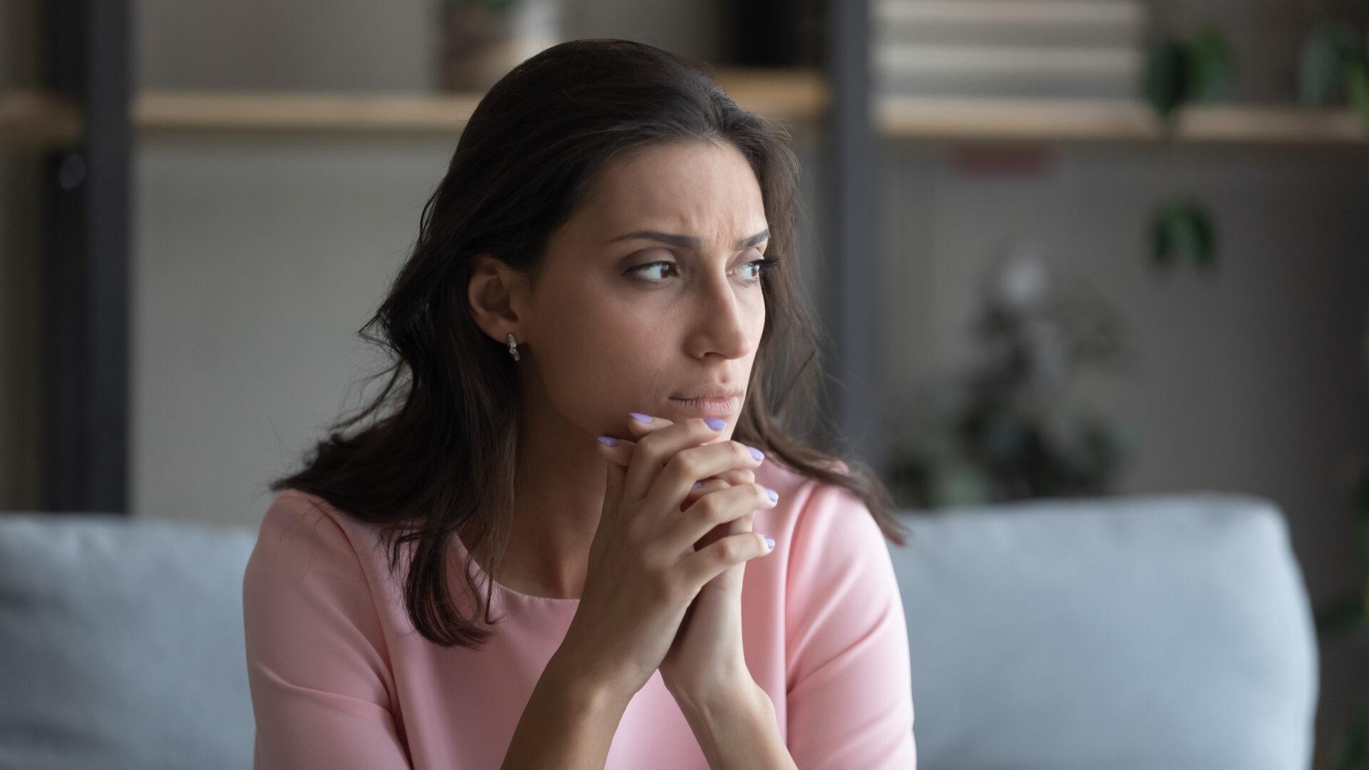 Anxious woman at home.