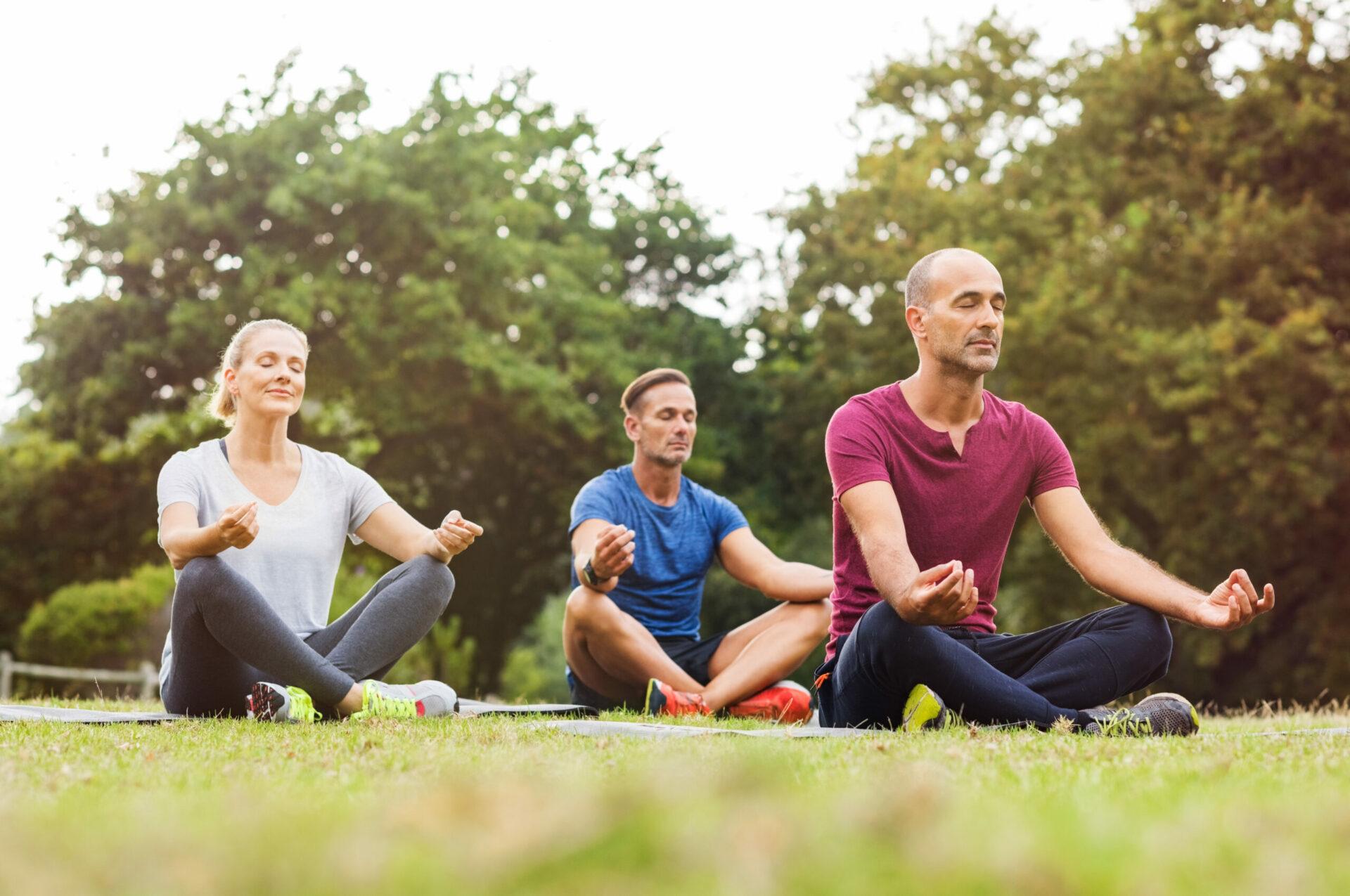 Group of people meditating outdoors