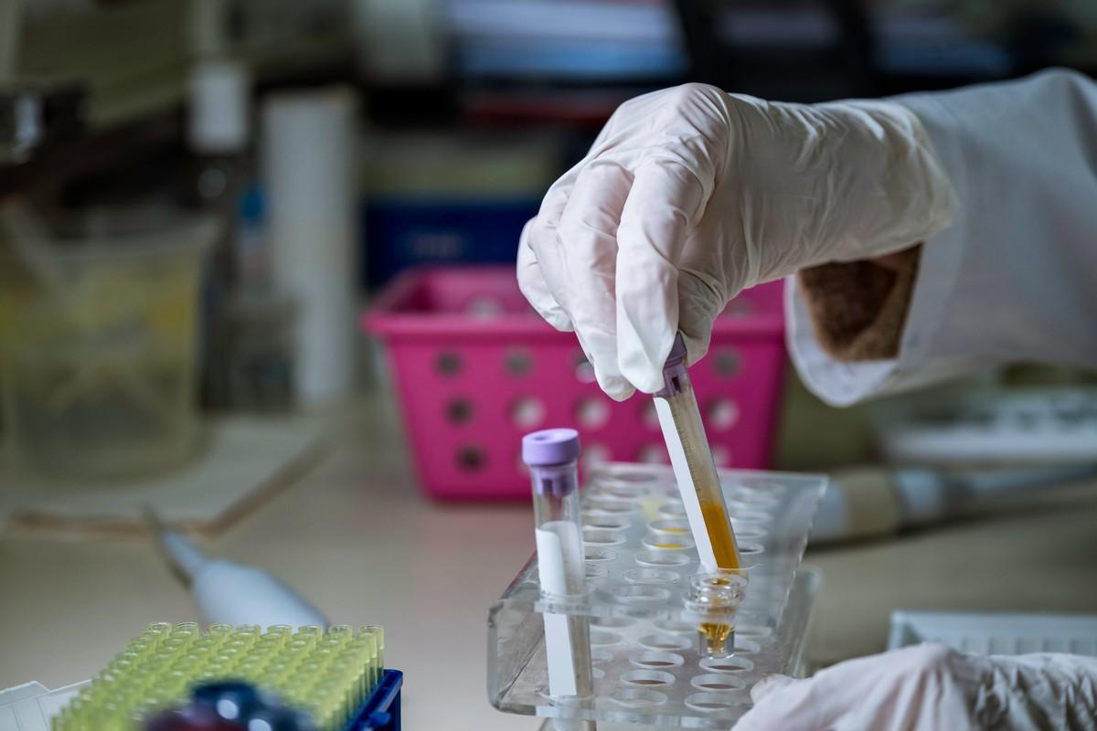 Lab technician with a plasma blood sample.