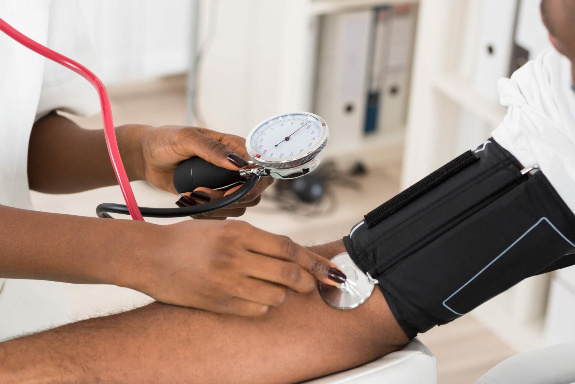 Doctor measuring patient’s blood pressure