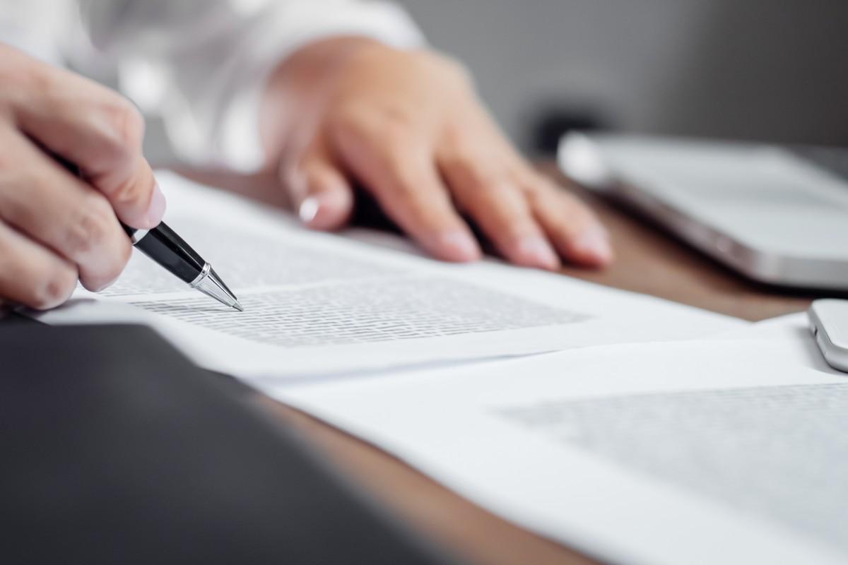 A person reviewing policy paperwork in the office.