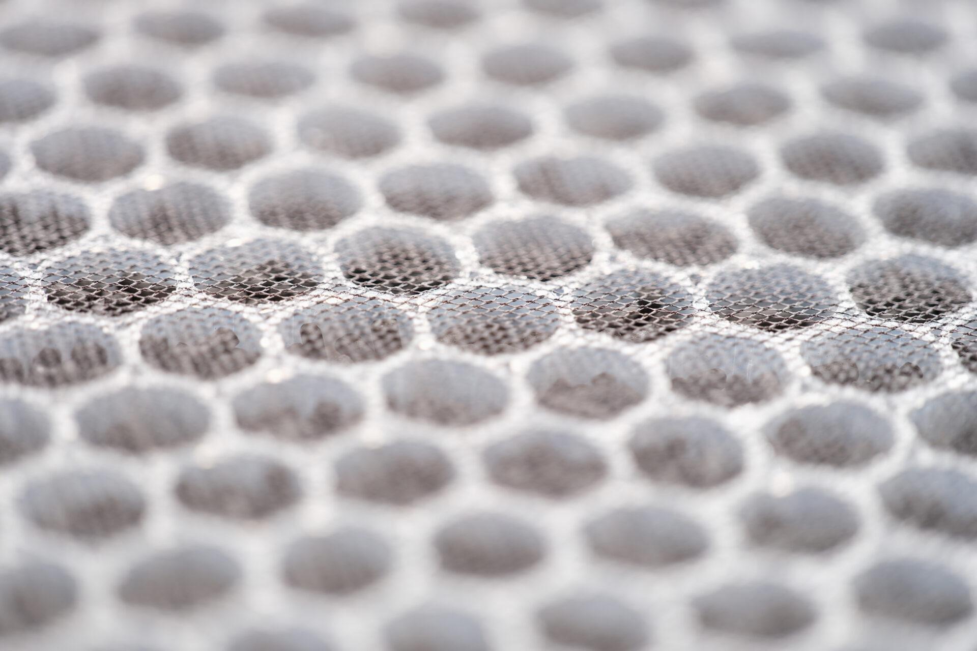 Close-up of a multi-stage air filter with UV radiation and activated carbon granules.