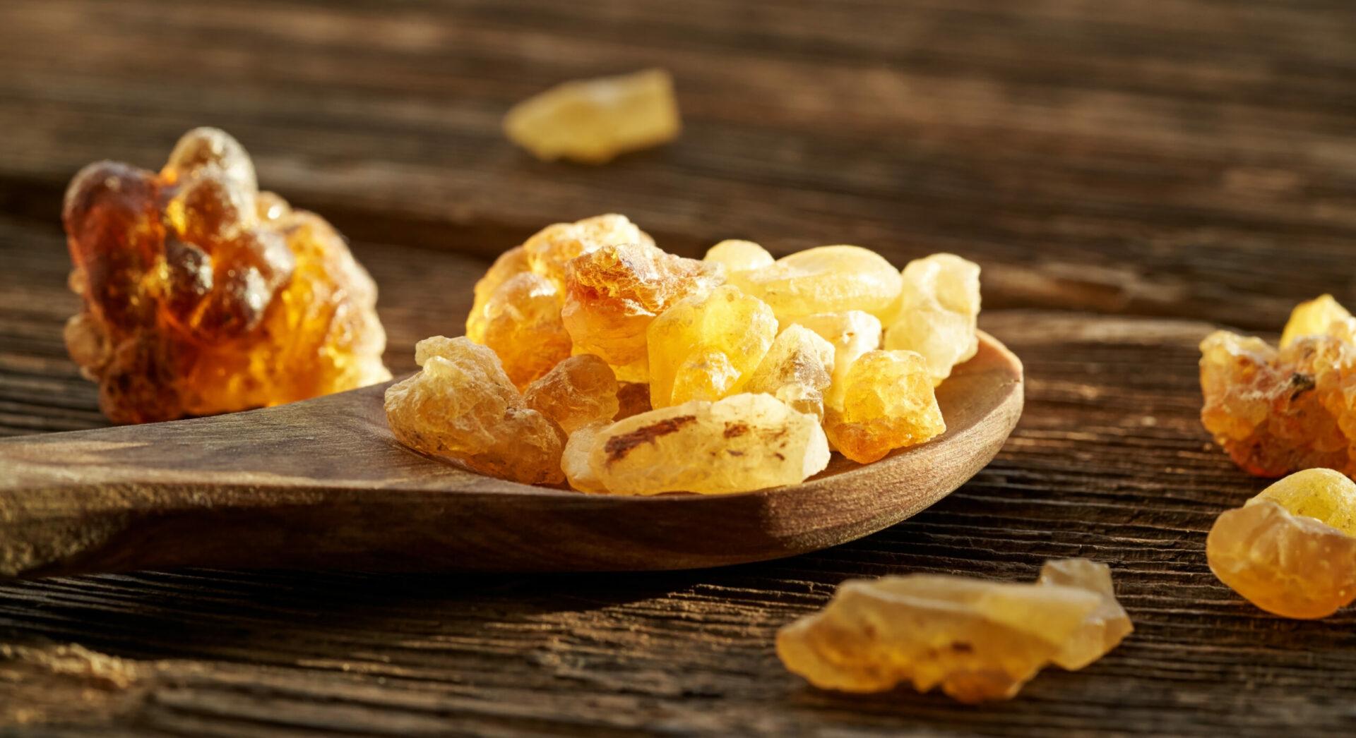 Frankincense resin crystals on a wooden spoon