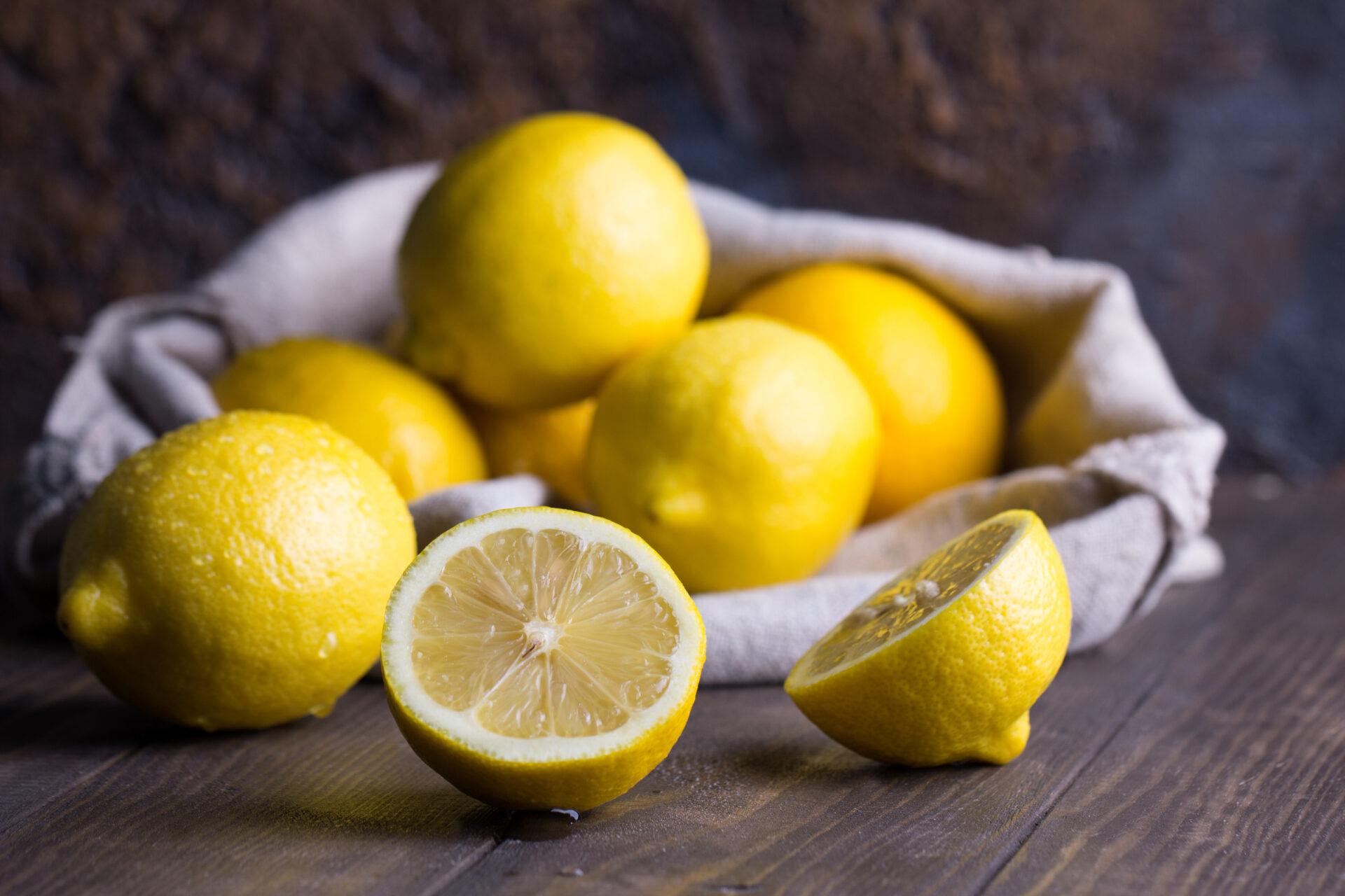 Group of fresh lemons on an old vintage wooden table.